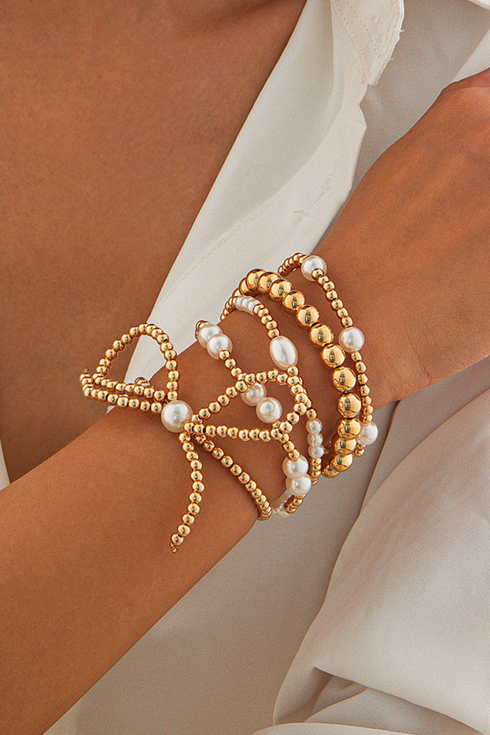 Set di Bracciali Multistrato con Fiocco Dorato e Perle