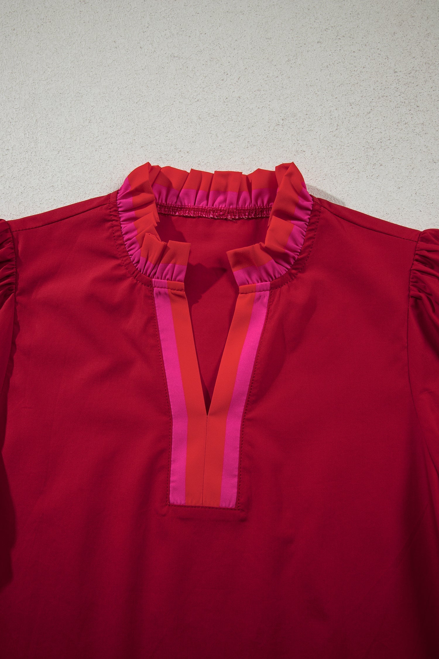 Flame-red striped blouse with a ruffled collar and short puff sleeves
