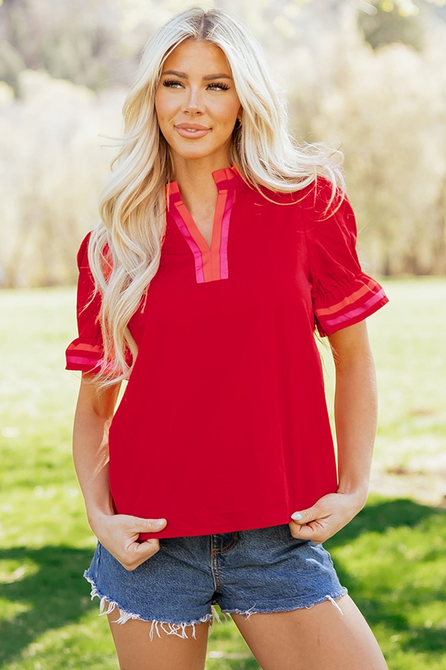 Flame-red striped blouse with a ruffled collar and short puff sleeves