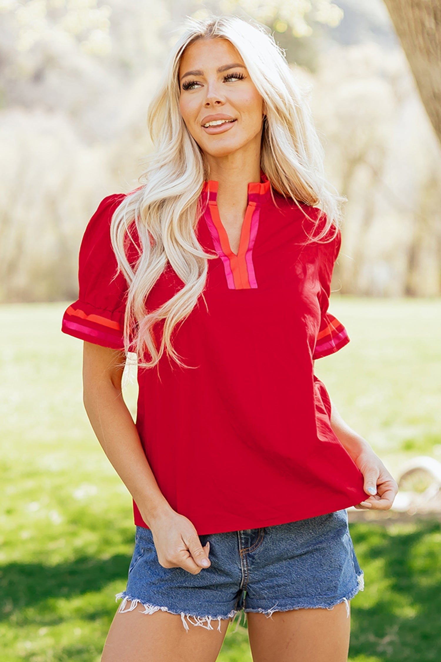 Flame-red striped blouse with a ruffled collar and short puff sleeves
